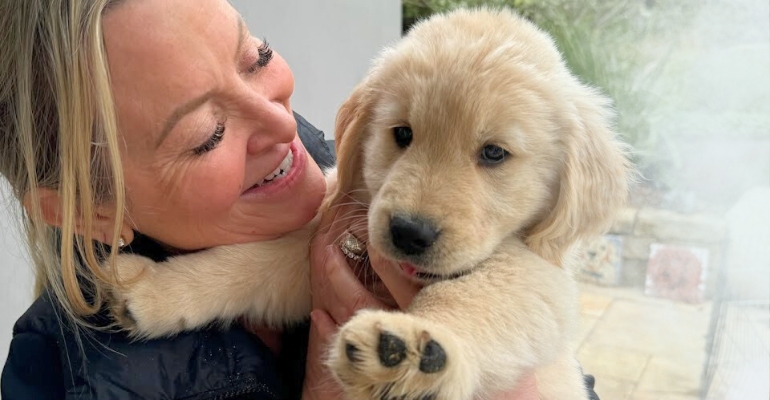a photo of Kristine Carlson with her new puppy Bohdi, feeling connection and love